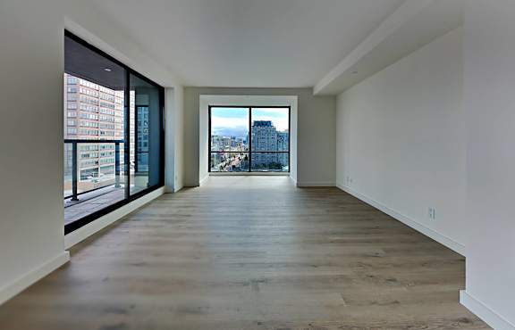 a living room with a large window and a wooden floor at 1700 California Street, San Francisco, 94109