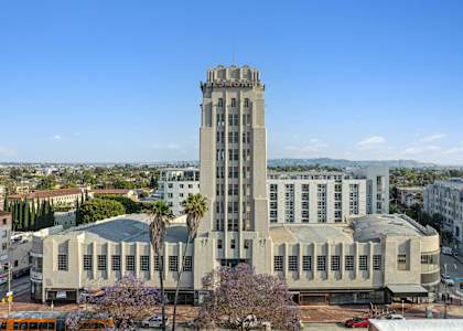 A large building with a tall tower and a lot of windows.