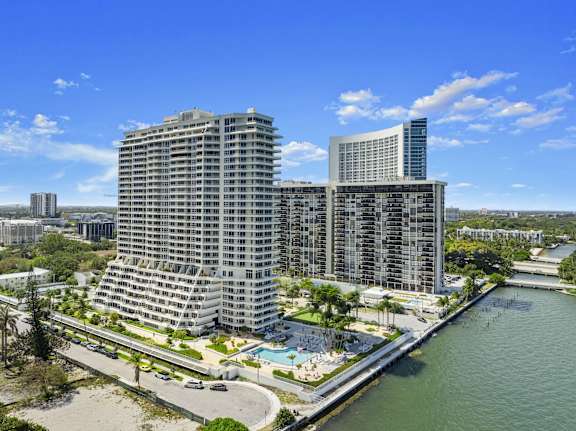 A large building with a pool in front of it. at The Hamilton, Miami, FL