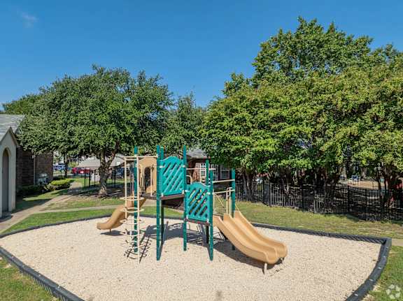 A playground with a slide, swings, and a sandbox.