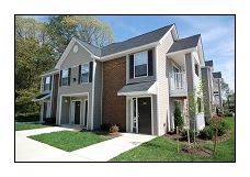 a large house with a sidewalk and grass in front of it