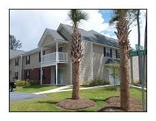 a house with two palm trees in front of it