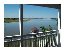 a balcony with a view of a lake and a gazebo