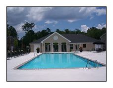 a large pool with a house in the background
