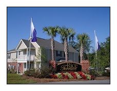 a large house with three flags in front of it