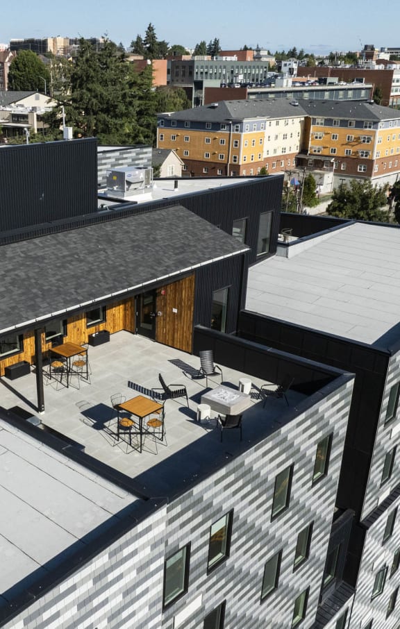 a kitchen with a wooden table and a black wall at Moraine, Tacoma