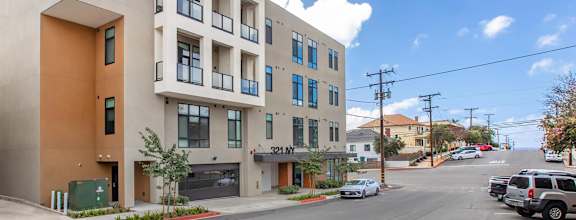 A modern apartment building with a clear blue sky above.