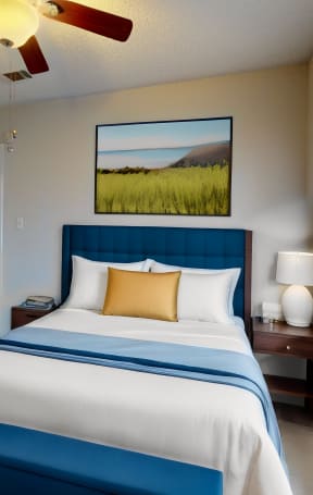 a bedroom with a large bed and a ceiling fan