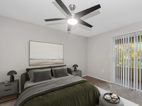 Model Bedroom with Carpet and Patio Accessibility at Walden Lake Apartments in Plant City, FL-LRGAM.