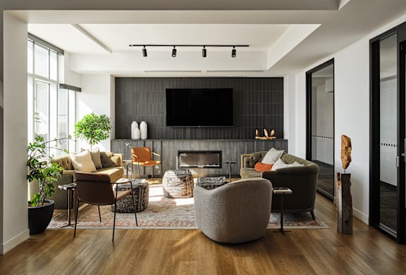 A modern living room with a fireplace and a flat screen TV. at Le Columbia Apartments , Gatineau, QC, J8Y 0A8