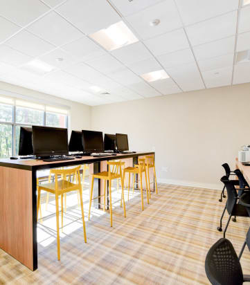 business center with computer stations and large windows at archer park apartments in southeast Washington dc
