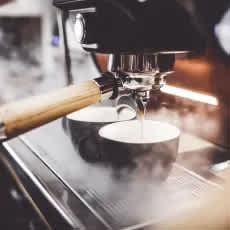 A coffee machine is dispensing coffee into a cup.