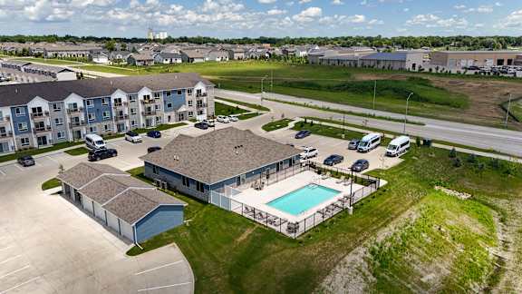 A large apartment complex with a swimming pool.