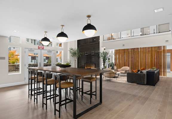 A modern dining room with a wooden table and chairs.