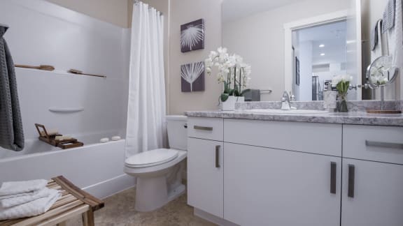 a bathroom with a toilet and a sink and a bath tub