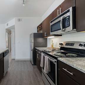 a kitchen with stainless steel appliances and granite counter tops and