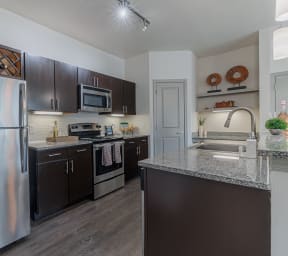 a kitchen with stainless steel appliances and granite counter tops