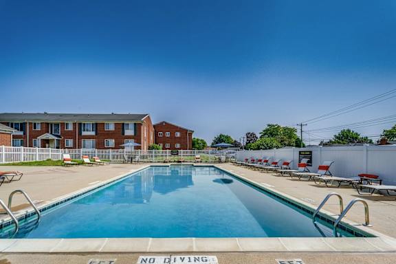 A pool with a no diving sign in the foreground.