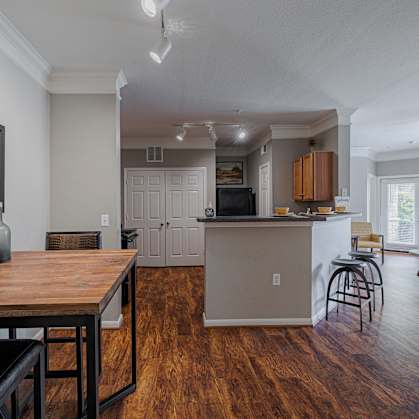 a living room with a dining room table and a kitchen