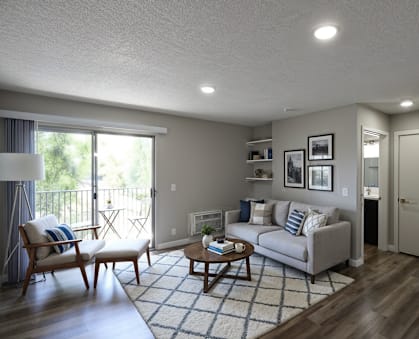 A living room with a couch, chair, and television.