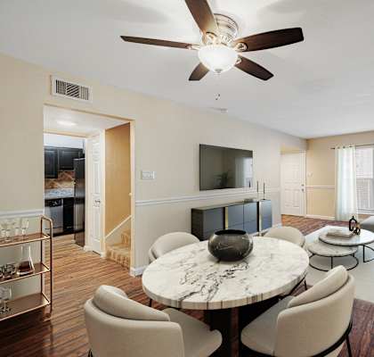 a living room with a ceiling fan and a large window