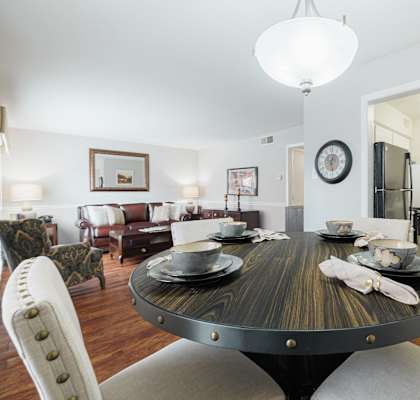 a dining room with a table and chairs and a living room