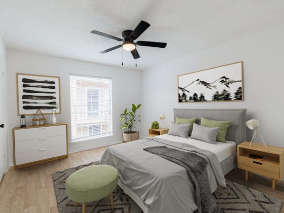 a bedroom with a large bed and a ceiling fan