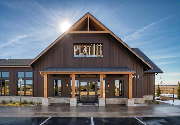 The Plato building has a dark brown facade and a black roof.