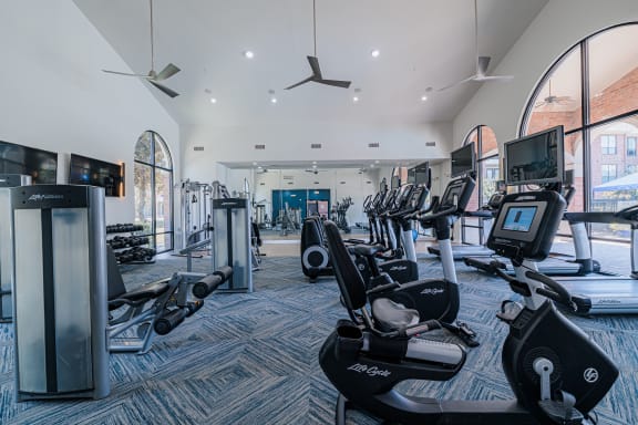 a large gym with cardio machines and other exercise equipment
