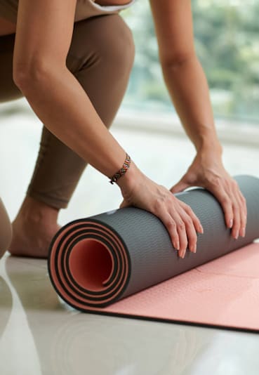 Woman is rolling up a yoga mat at The Hawthorn, Pennsylvania