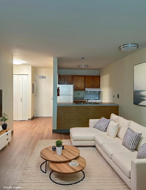 A living room with a white couch and a coffee table.
