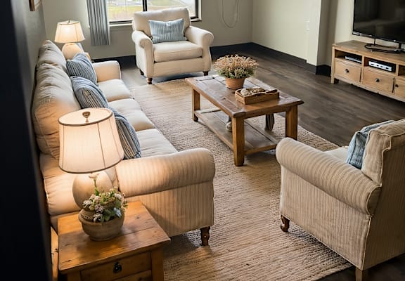 A living room with a couch, chair, and television.