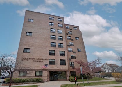 a large brick building with an american flag in front of it