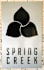 A sign that says Spring Creek with a black and white graphic of three leaves.