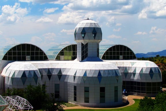 a large building with many domes and a blue sky
