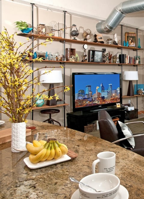a living room filled with furniture and a table with bananas at Buzza Lofts of Uptown, Minneapolis Minnesota
