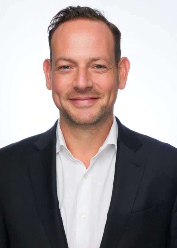 a man wearing a suit and a white shirt and a black