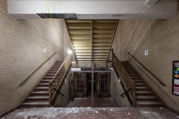 the inside of a building with stairs and a door