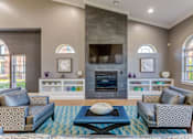 Thumbnail 4 of 8 - A living room with a fireplace and a blue rug.
