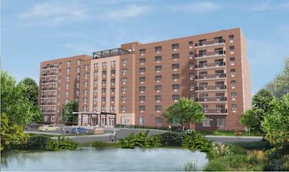 a computer generated image of a large brick building next to a body of water