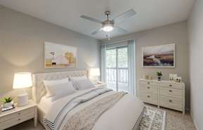 the master bedroom has a comfy bed and a ceiling fan