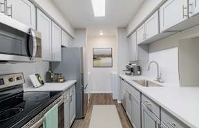 a bathroom with a sink and a shower and a mirror