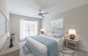 the master bedroom has a comfy bed and a ceiling fan