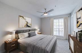 the master bedroom has a comfy bed and a ceiling fan
