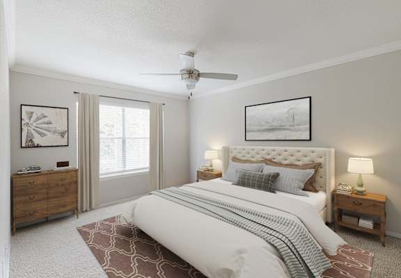 A bedroom with a large bed, a ceiling fan, and a dresser.