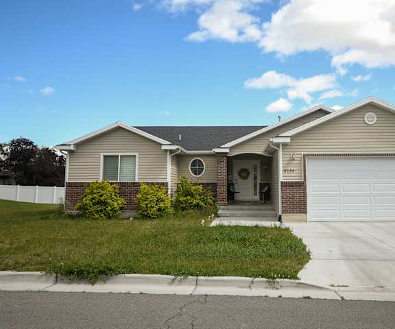 a tan house with a white garage door