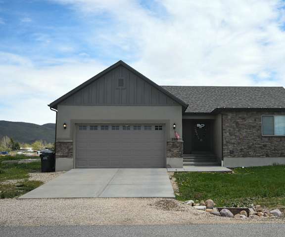 the front of a house with a driveway and a garage door