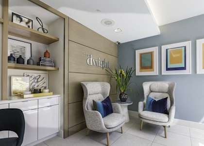 two chairs with blue pillows in a waiting room