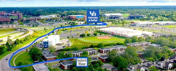 A blue line is drawn on an aerial view of a university campus.