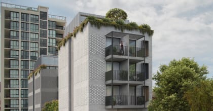 a tall building with balconies and a tree on top of it